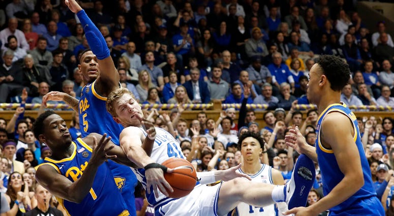 Duke forward Jack White (41) struggles for a rebound with Pittsburgh guard Xavier Johnson (1) and guard Au'Diese Toney (5) during the second half of an NCAA college basketball game Duke forward Jack White (41) struggles for a rebound with Pittsburgh guard Xavier Johnson (1) and guard Au'Diese Toney (5) during the second half of an NCAA college basketball game