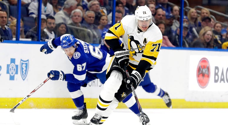 Pittsburgh Penguins center Evgeni Malkin (71) breaks out ahead of Tampa Bay Lightning center Mitchell Stephens (67) during the first period of an NHL hockey game Thursday, Feb. 6, 2020, in Tampa, Fla.