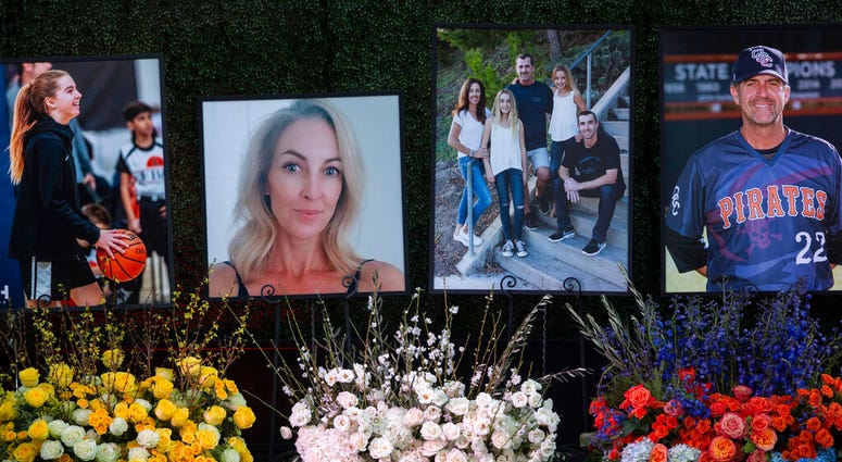 Flowers and photos honor members of the Altobelli family outside Angel Stadium, Monday, Feb. 10, 2020, in Anaheim, Calif. Coach John Altobelli, 56, far right, his wife, Keri, 43, second from left, and his daughter Alyssa, 13, left, died in a helicopter cr