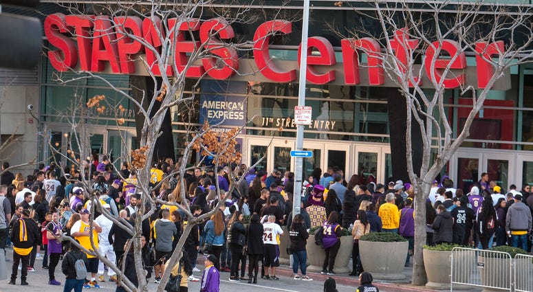 Fans line up to get into the Staples Center to attend a public memorial for former Los Angeles Lakers star Kobe Bryant and his daughter, Gianna, in Los Angeles, Monday, Feb. 24, 2020.