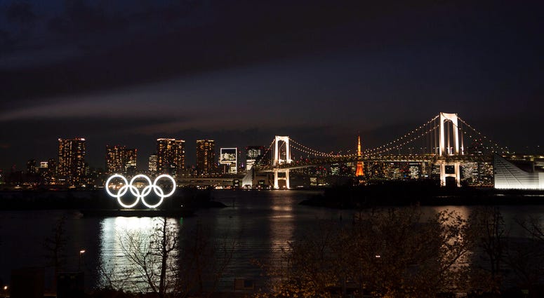 The Olympic rings float in the water near the Rainbow Bridge in the Odaiba section of Tokyo, Monday, March 23, 2020. The Tokyo Olympics are going to happen — but almost surely in 2021 rather than in four months as planned. (AP Photo/Jae C. Hong