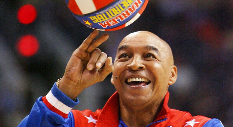 Harlem Globetrotters' Fred "Curly" Neal performs during a timeout in the second quarter in an NBA basketball game Harlem Globetrotters' Fred "Curly" Neal performs during a timeout in the second quarter in an NBA basketball game