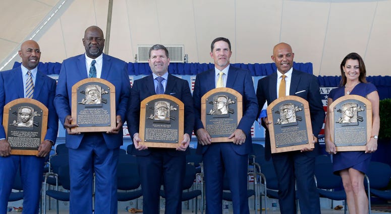 : Inductees (from left) Harold Baines, Lee Smith, Edgar Martinez, Mike Mussina, Mariano Rivera and Brandy Halladay, wife the late Roy Halladay, pose with their plaques