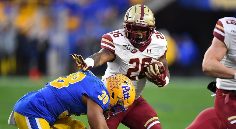 PITTSBURGH, PA - NOVEMBER 30: David Bailey #26 of the Boston College Eagles carries the ball in front of Cam Bright #38 of the Pittsburgh Panthers in the first quarter at Heinz Field on November 30, 2019 in Pittsburgh, Pennsylvania.