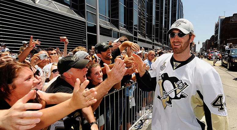 PITTSBURGH - JUNE 15: Brooks Orpik #44 of the Pittsburgh Penguins greets fans during the Penguins' Stanley Cup Champion Victory Parade on June 15, 2009 in Pittsburgh, Pennsylvania. (