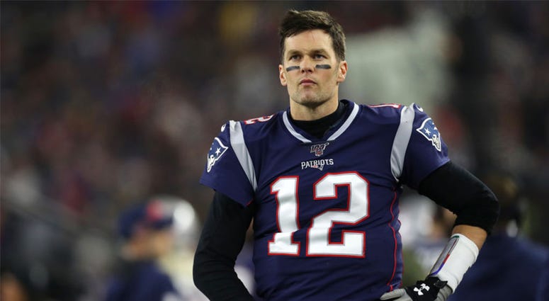 Tom Brady #12 of the New England Patriots looks on from the sideline Tom Brady #12 of the New England Patriots looks on from the sideline