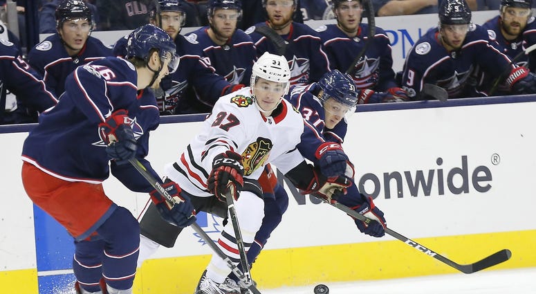Columbus Blue Jackets defenseman Dean Kukan (46) and Jackets left wing Markus Hannikainen (37) defend Chicago Blackhawks left wing Graham Knott Columbus Blue Jackets defenseman Dean Kukan (46) and Jackets left wing Markus Hannikainen (37) defend Chicago Blackhawks left wing Graham Knott