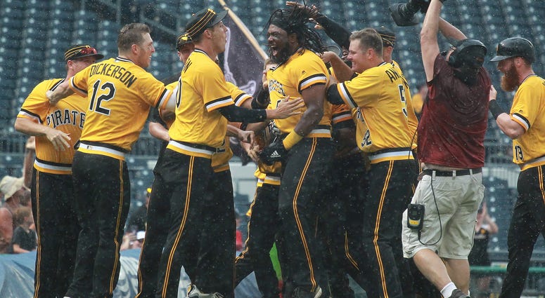 Pittsburgh Pirates first baseman Josh Bell (middle) is mobbed by teammates after driving in the game winning run against the Milwaukee Brewers during the tenth inning at PNC Park. Pittsburgh won 7-6.