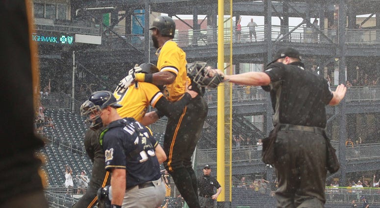 Pittsburgh Pirates third baseman Colin Moran (19) and right fielder Gregory Polanco (25) celebrate after Moran scored the game winning run