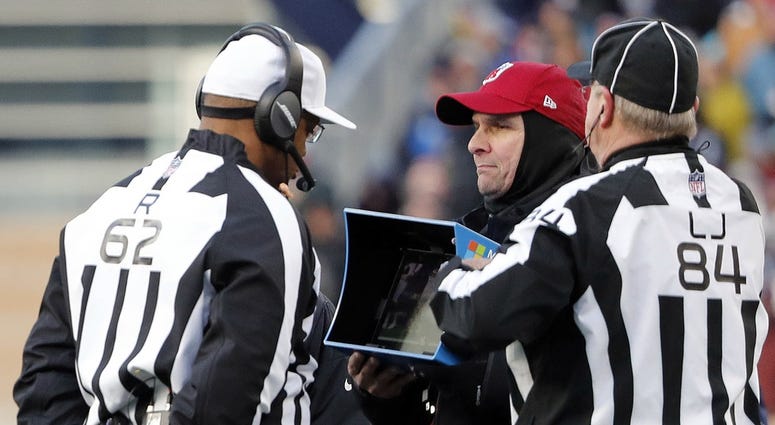 NFL referees wait for a replay during game NFL referees wait for a replay during game