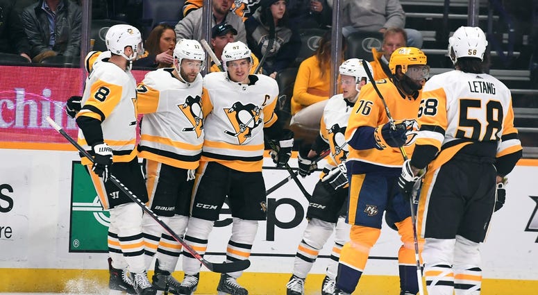 Bryan Rust (17) celebrates with teammates after scoring during the second period