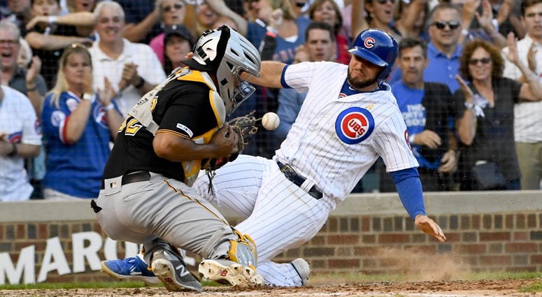Chicago Cubs third baseman David Bote scores past Pittsburgh Pirates catcher Elias Diaz Chicago Cubs third baseman David Bote scores past Pittsburgh Pirates catcher Elias Diaz