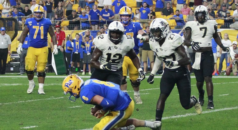 Pittsburgh, PA, USA; Pittsburgh Panthers quarterback Kenny Pickett (8) catches a four yard game winning touchdown pass on a trick play against UCF