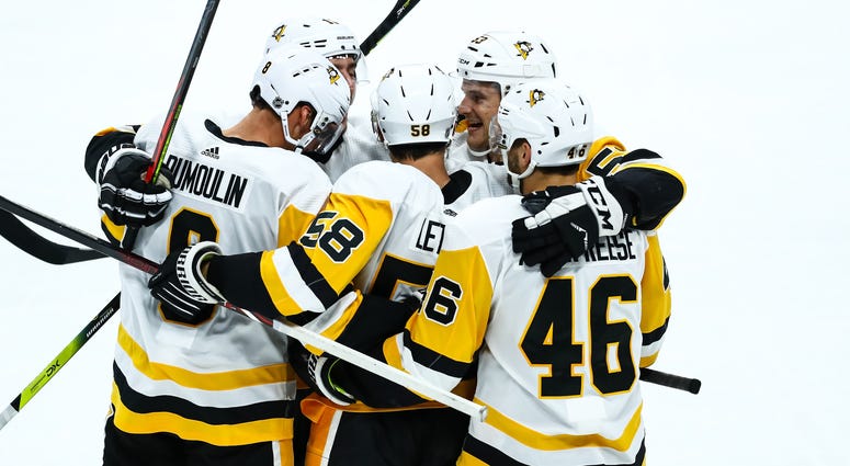Pittsburgh Penguins defenseman Kris Letang is congratulated by his teammates after scoring a goal Pittsburgh Penguins defenseman Kris Letang is congratulated by his teammates after scoring a goal
