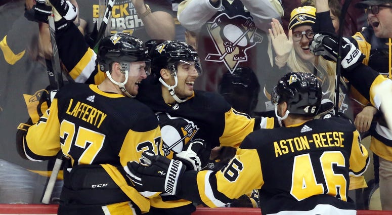 Pittsburgh Penguins left wing Brandon Tanev (middle) celebrates his game winning goal with center Sam Lafferty (37) and center Zach Aston-Reese (46) against the Colorado Avalanche in overtime at PPG PAINTS Arena. Pittsburgh Penguins left wing Brandon Tanev (middle) celebrates his game winning goal with center Sam Lafferty (37) and center Zach Aston-Reese (46) against the Colorado Avalanche in overtime at PPG PAINTS Arena.