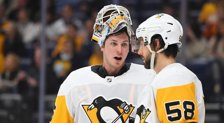 ittsburgh Penguins goaltender Tristan Jarry (35) talks with Pittsburgh Penguins defenseman Kris Letang