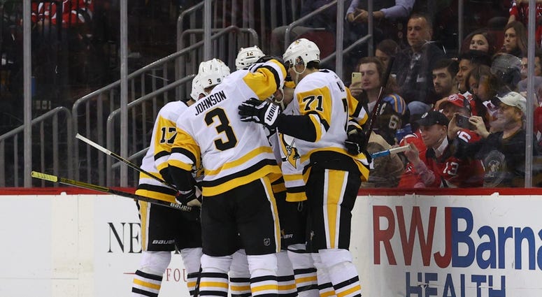 The Pittsburgh Penguins celebrate after a goal by defenseman Justin Schultz (4) against the New Jersey Devils during the second period at Prudential Center.
