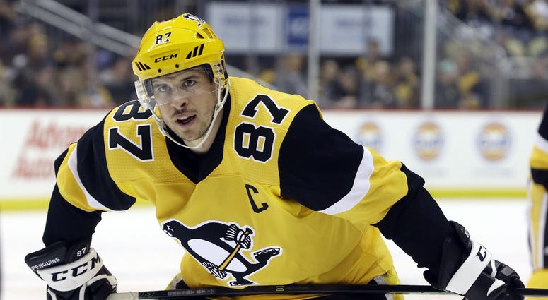 Penguins center Sidney Crosby looks on before a face-off Penguins center Sidney Crosby looks on before a face-off