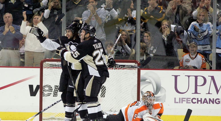 Pittsburgh Penguins Kris Letang (58) and Max Talbot (25) celebrate scoring in front of Philadelphia Flyers goalie Sergei Bobrovsky (35) during the first period at the CONSOL Energy Center.