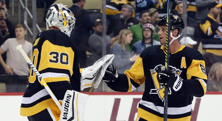 Pittsburgh Penguins goaltender Matt Murray (30) and defenseman Brian Dumoulin (8) celebrate after defeating the Anaheim Ducks at PPG PAINTS Arena. Pittsburgh won 2-1.