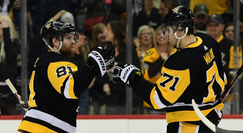 Pittsburgh Penguins forward Phil Kessel (81), left, celebrates with forward Evgeni Malkin (71) after scoring a goal during the second period against the Detroit Red Wings at PPG PAINTS Arena.
