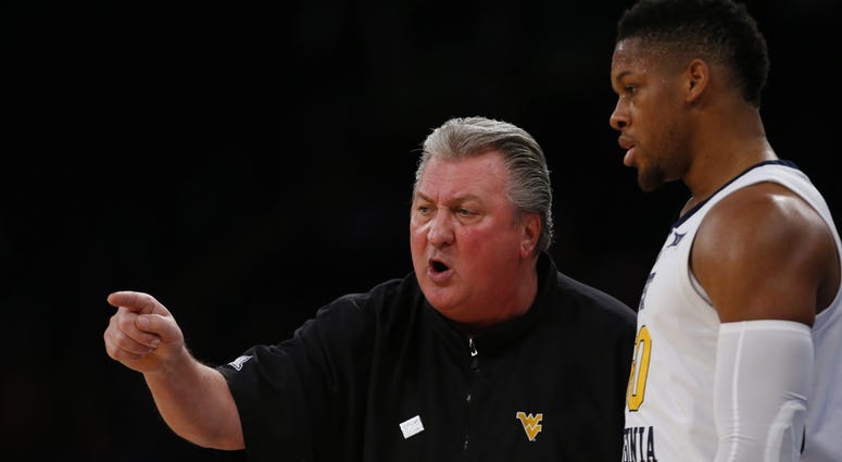 West Virginia Mountaineers head coach Bob Huggins talks to forward Sagaba Konate (50) during the second half against the Florida Gators at Madison Square Garden.
