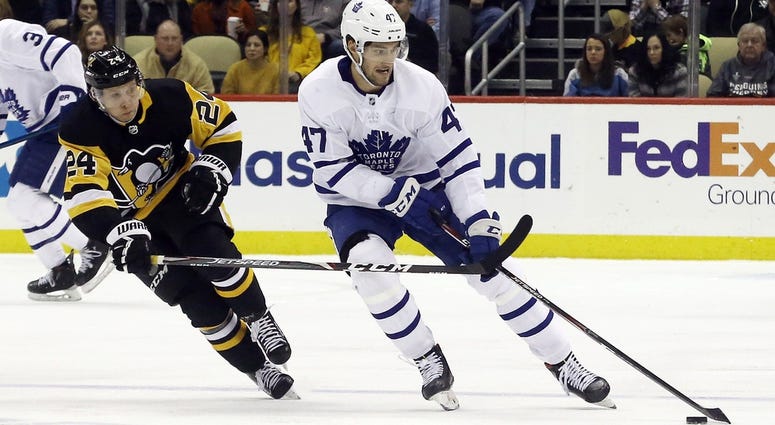 Toronto Maple Leafs left wing Pierre Engvall (47) skates with the puck against pressure from Pittsburgh Penguins center Dominik Kahun (24) during the third period at PPG PAINTS Arena. Pittsburgh won 5...