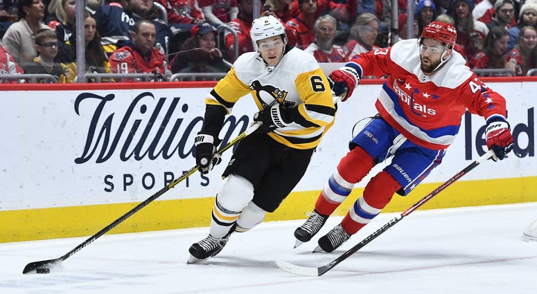 Pittsburgh Penguins defenseman John Marino (6) carries the puck as Washington Capitals right wing Tom Wilson (43) chases during the first period at Capital One Arena.
