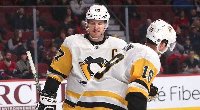 Pittsburgh Penguins center Jared McCann (19) celebrates his goal in a Montreal Canadiens empty net with teammate center Sidney Crosby (87) during the third period at Bell Centre.