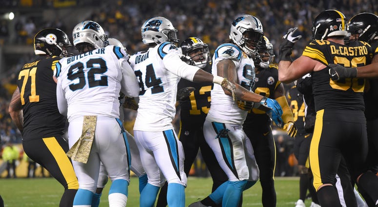 Players from the Pittsburgh Steelers and Carolina Panthers push and shove each other after a hit by Carolina safety Eric Reid against Pittsburgh quarterback Ben Roethlisberger during the third quarter