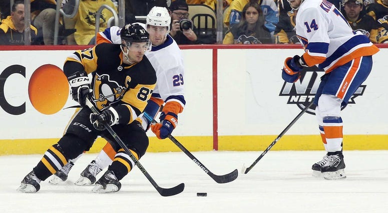 Pittsburgh Penguins center Sidney Crosby (87) handles the puck against New York Islanders center Brock Nelson (29) during the third period in game three of the first round of the 2019 Stanley Cup Playoffs