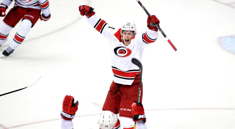 Carolina Hurricanes left wing Brock McGinn (23) celebrates his game-winning goal with Justin Williams (14) in double overtime of Game 7 of an NHL hockey first-round playoff series against the Washington Capitals, Wednesday, April 24, 2019, in Washington. AP DO NOT USE