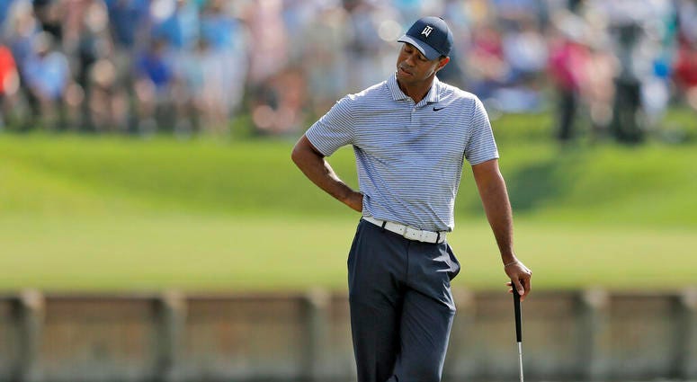 Tiger Woods reacts to hitting his drive into the water on the 17th hole during the second round of The Players Championship golf tournament Friday, March 15, 2019, in Ponte Vedra Beach, Fla Tiger Woods reacts to hitting his drive into the water on the 17th hole during the second round of The Players Championship golf tournament Friday, March 15, 2019, in Ponte Vedra Beach, Fla