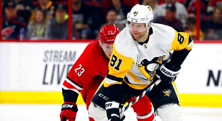 Pittsburgh Penguins' Phil Kessel (81) takes the puck away from Carolina Hurricanes' Brock McGinn (23) during the first period of an NHL hockey game, Tuesday, March 19, 2019, in Raleigh, N.C. Pittsburgh Penguins' Phil Kessel (81) takes the puck away from Carolina Hurricanes' Brock McGinn (23) during the first period of an NHL hockey game, Tuesday, March 19, 2019, in Raleigh, N.C.