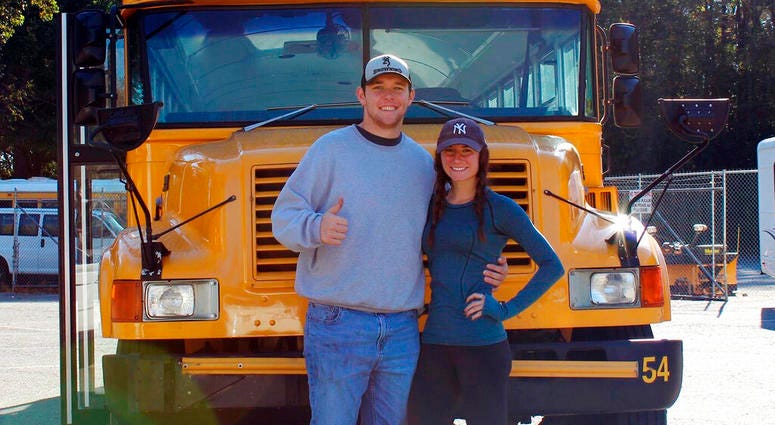 Jack Labosky, left, and Madi Hiatt pose after purchasing a school bus in Lynchburg, Va. Jack Labosky, left, and Madi Hiatt pose after purchasing a school bus in Lynchburg, Va.