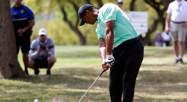 Tiger Woods hits from the rough on the sixth hole during round-robin play at the Dell Match Play Championship golf tournament, Thursday, March 28, 2019, in Austin, Texas. ( Tiger Woods hits from the rough on the sixth hole during round-robin play at the Dell Match Play Championship golf tournament, Thursday, March 28, 2019, in Austin, Texas. (