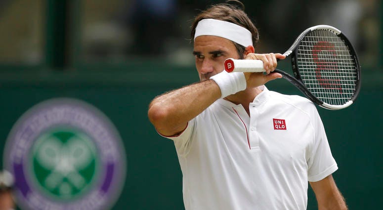 Roger Federer of Switzerland wipes his face during his men's singles match against France's Adrian Mannarino, DO NOT USE