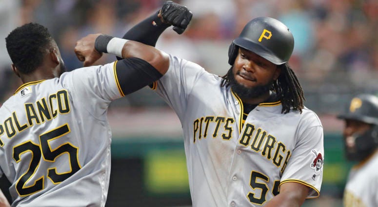Pittsburgh Pirates' Josh Bell, right, is congratulated by Gregory Polanco after Bell hit a two-run home run in the fifth inning of a baseball game, Tuesday, July 24, 2018, in Cleveland. DO NOT USE