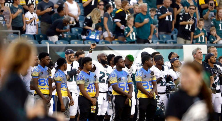 Philadelphia Eagles' Malcolm Jenkins, center left, raises his fist during the national anthem before the team's preseason NFL football game against the Pittsburgh Steelers, Thursday, Aug. 9, 2018, in Philadelphia. DO NOT USE