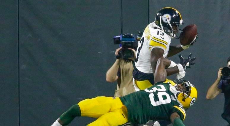 Pittsburgh Steelers' James Washington catches a touchdown pass over Green Bay Packers' Demetri Goodson during the second half of a preseason NFL football game Thursday, Aug. 16, 2018, in Green Bay, Wis. DO NOT USE