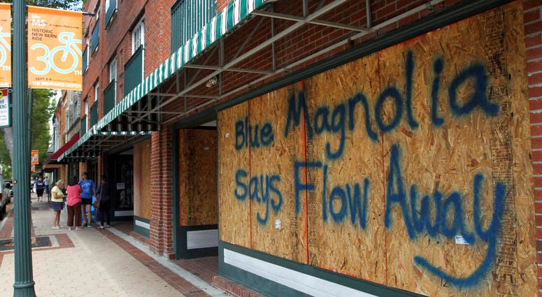 Storefronts have wood paneling installed over windows, Tuesday, Sept. 11, 2018, in New Bern, N.C., as a precaution against storm damage from Hurricane Florence. DO NOT USE