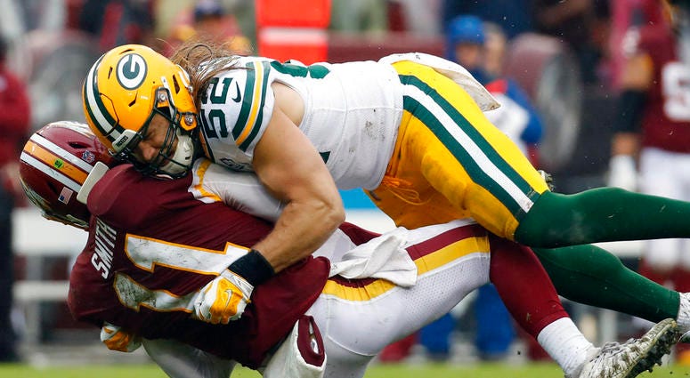 Green Bay Packers linebacker Clay Matthews (52) hits Washington Redskins quarterback Alex Smith (11) during the second half of an NFL football game, Sunday, Sept. 23, 2018 in Landover, Md. DO NOT USE