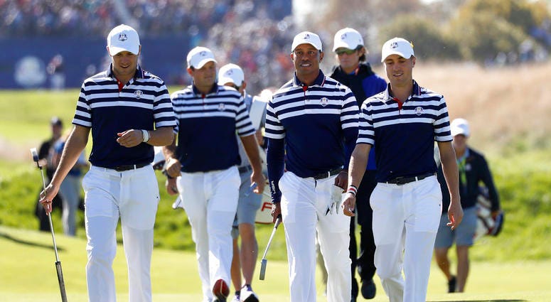 Jordan Spieth of the US, Patrick Reed, Tiger Woods and Justin Thomas, from left, walk to the 18th green during a practice round for the Ryder Cup DO NOT USE