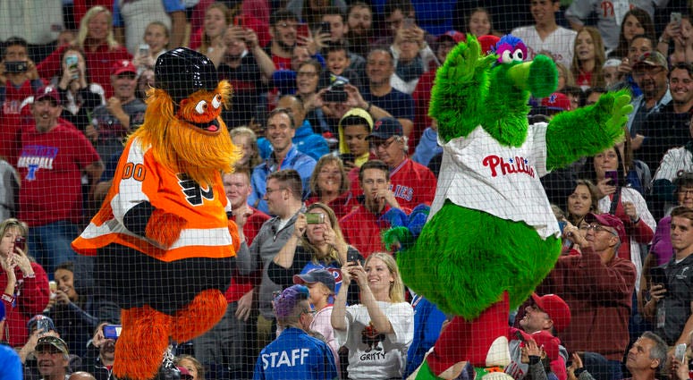 Sept. 29, 2018, file photo, Gritty, the Philadelphia Flyers' mascot, left, and the Philly Phanatic dance during a baseball game between the Philadelphia Phillies and the Atlanta Braves, DO NOT USE