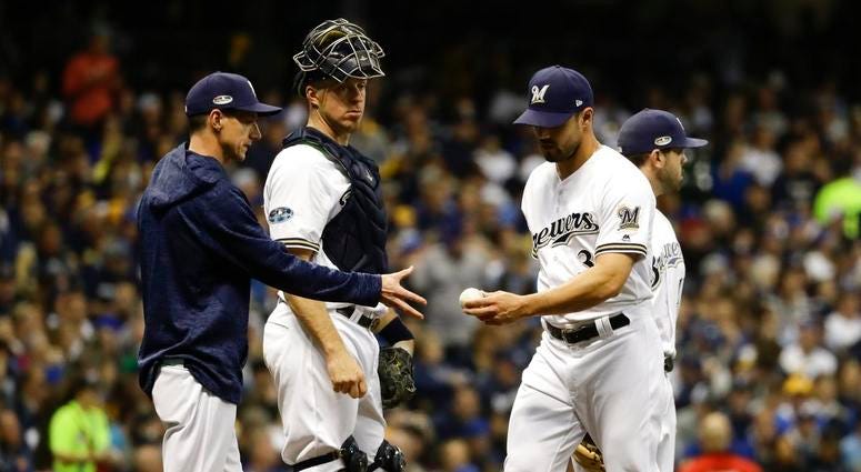 Milwaukee Brewers manager Craig Counsell takes relief pitcher Xavier Cedeno out of the game Milwaukee Brewers manager Craig Counsell takes relief pitcher Xavier Cedeno out of the game