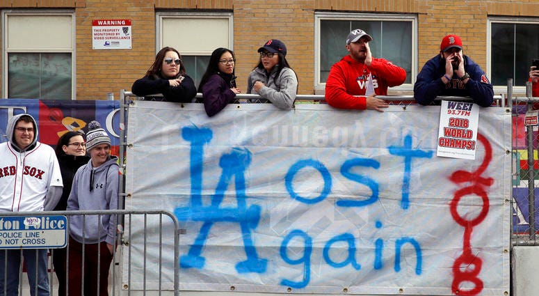Boston Red Sox fans line the parade route, waiting to celebrate the team's World Series championship over the Los Angeles Dodgers, Wednesday, Oct. 31, 2018, in Boston. DO NOT USE