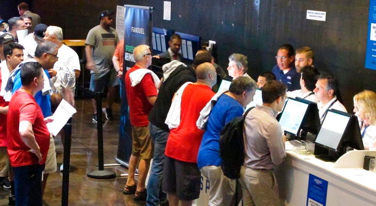 This July 14, 2018 file photo shows gamblers placing bets on sports events at the FanDuel sports book at the Meadowlands Racetrack in East Rutherford, N.J., DO NOT USE
