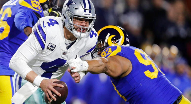 Dallas Cowboys quarterback Dak Prescott breaks away from Los Angeles Rams Dallas Cowboys quarterback Dak Prescott breaks away from Los Angeles Rams