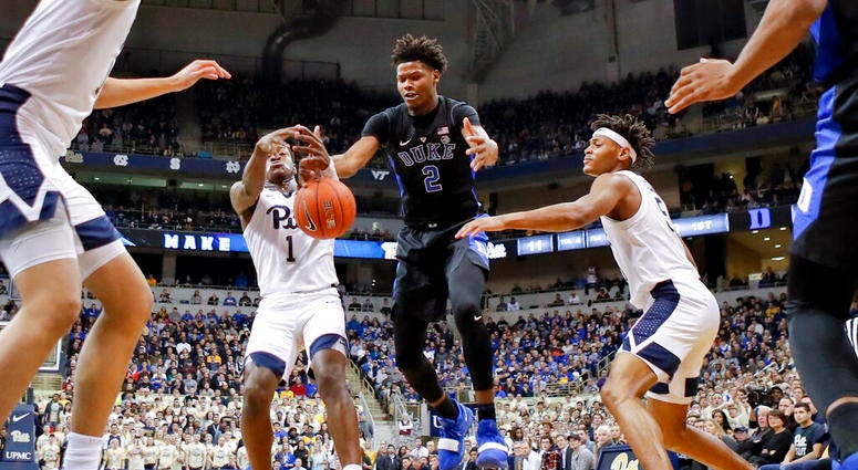 Pittsburgh's Xavier Johnson (1) and Duke's Cam Reddish (2) chase a loose ball during the first half of an NCAA college basketball game, Tuesday, Jan. 22, 2019, in Pittsburgh. DO NOT USE