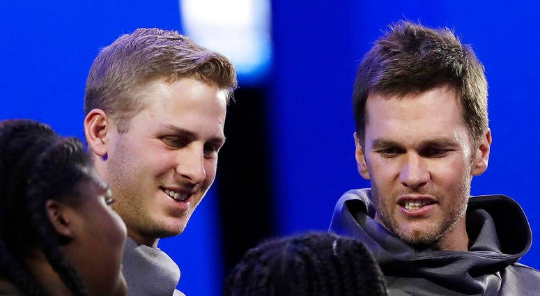 Los Angeles Rams' Jared Goff and New England Patriots' Tom Brady speaks with children during Opening Night for the NFL Super Bowl 53 football game Monday, AP DO NOT USE